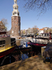 city tower along canal & boats