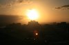 sunset behind building